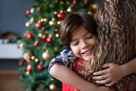child hugging parent during christmas